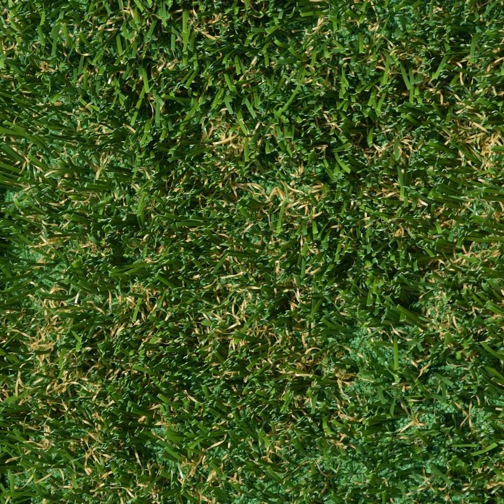 A close up image of artificial grass that is green with some brown.